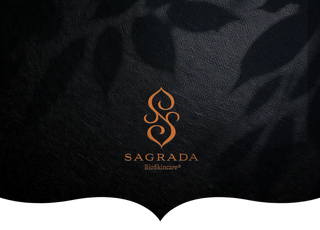 The Sagrada BioSkincare logo in an elegant orange design, displayed on a textured black background with soft shadowed patterns.