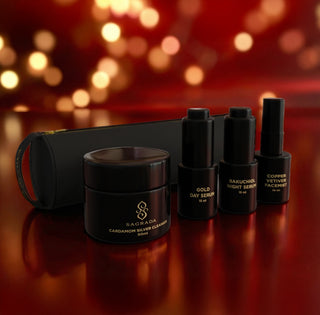 Sagrada travel-size skincare set with Cardamom Silver Cleanser, day and night serums, and Copper Vetiver Facial Mist, styled as a gift