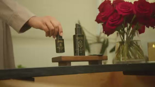Woman performing her skincare ritual with Sagrada BioSkincare—opening, applying, and massaging product into her face in a calming, intentional sequence