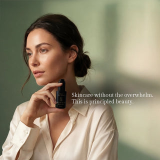 Woman holding Sagrada Gold Day Serum in a luxury skincare lifestyle image promoting radiant, balanced skin and a simplified beauty ritual