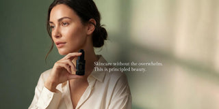 Woman holding Sagrada Gold Day Serum in a luxury skincare lifestyle image promoting radiant, balanced skin and a simplified beauty ritual