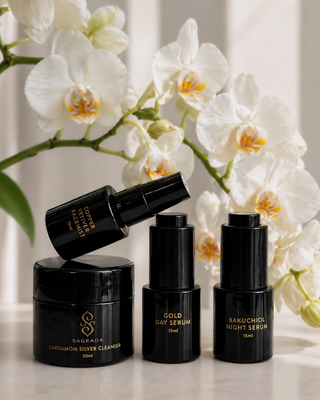 Sagrada BioSkincare travel-size skincare ritual set with serums, cleanser, and facial mist displayed in a luxury lifestyle setting